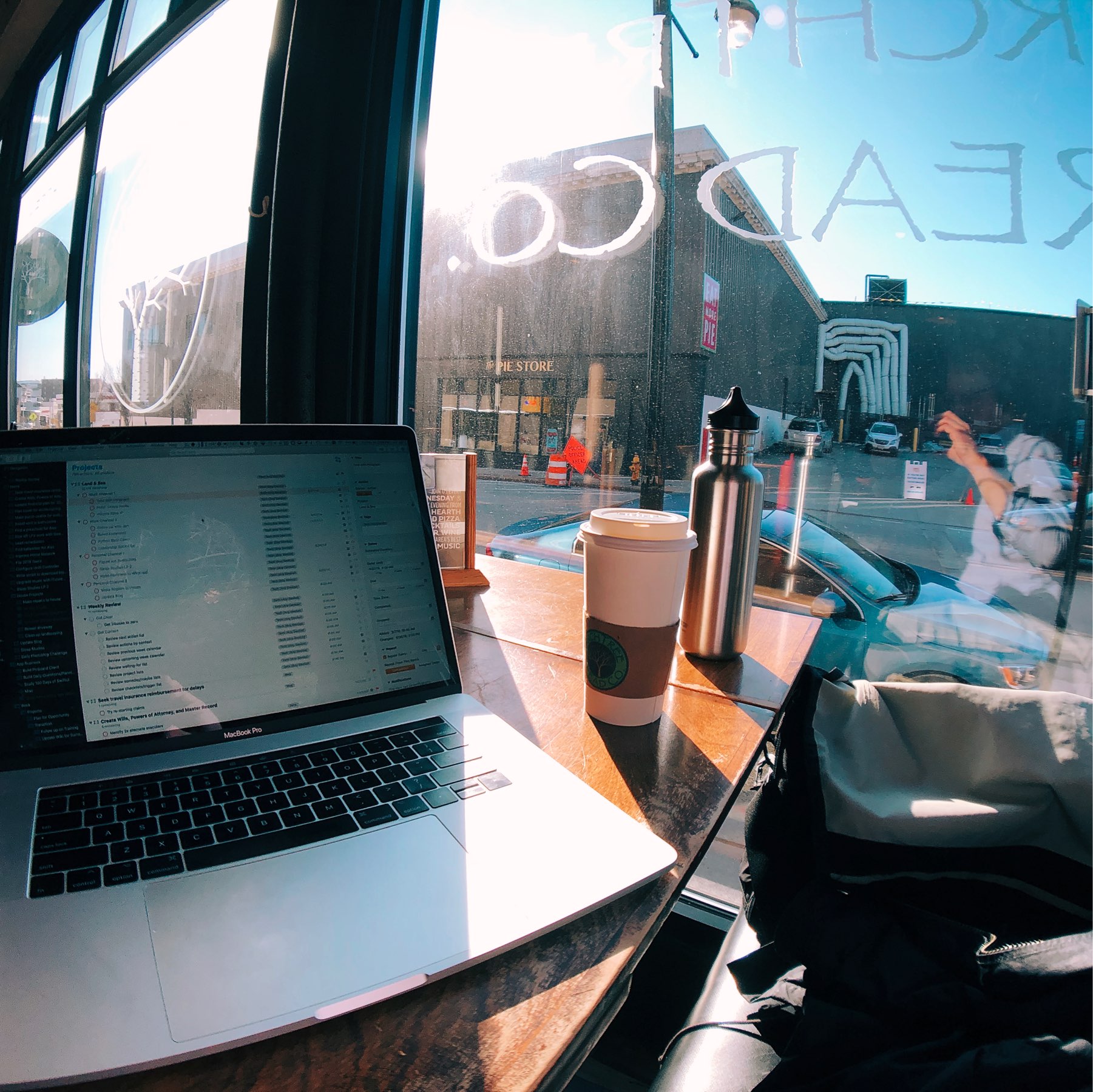 Laptop in sun at coffee shop.